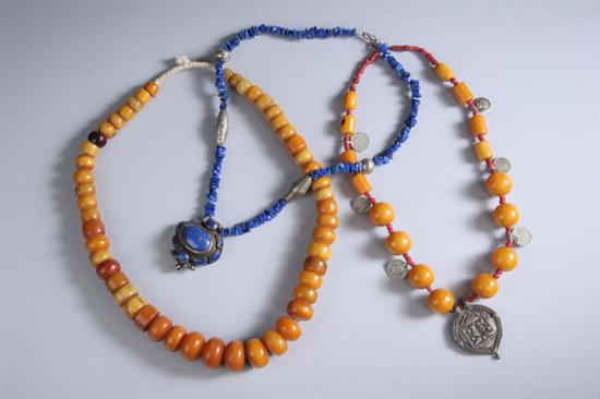 Appraisal: TWO AMBER NECKLACES One with amber one with coral beads