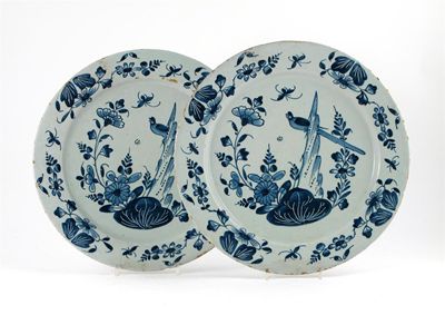 Appraisal: A pair of Delft blue and white plates painted with