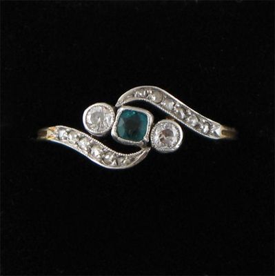 Appraisal: An emerald and diamond cross over ring set with a