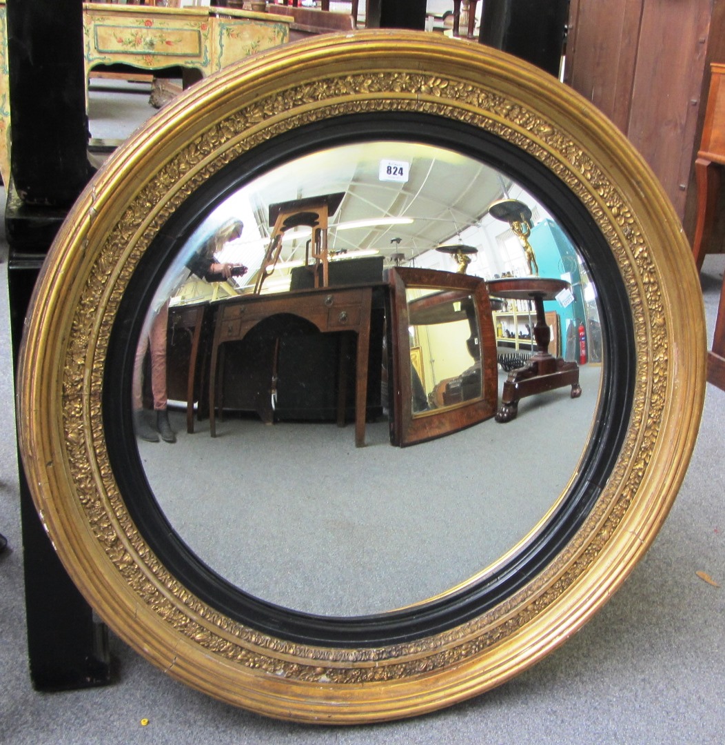 Appraisal: A Regency gilt framed convex circular wall mirror with ebonised