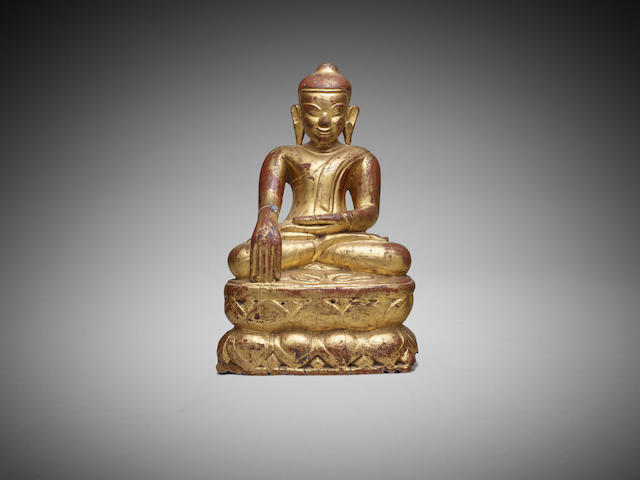 Appraisal: A Burmese dark red and gold lacquered wood seated figure