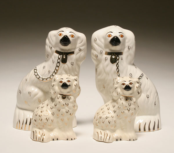 Appraisal: Two pairs Beswick Staffordshire type spaniels painted gilt accents and