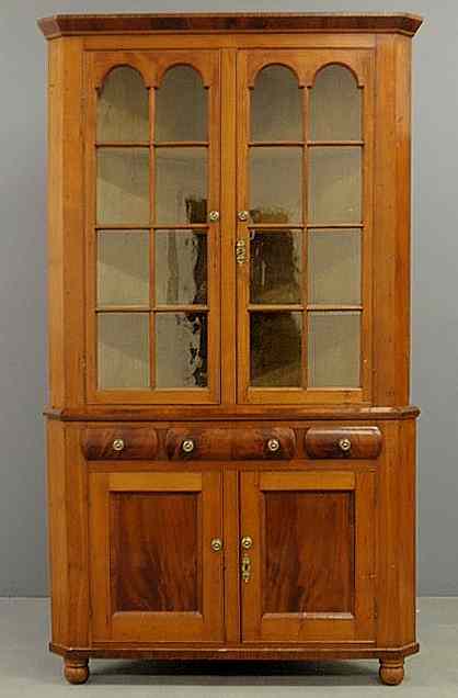 Appraisal: New York cherry and mahogany two-part corner cupboard c the