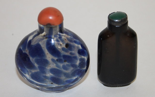 Appraisal: A BEIJING OVIFORM GLASS SNUFF BOTTLE decorated irregular blue spots