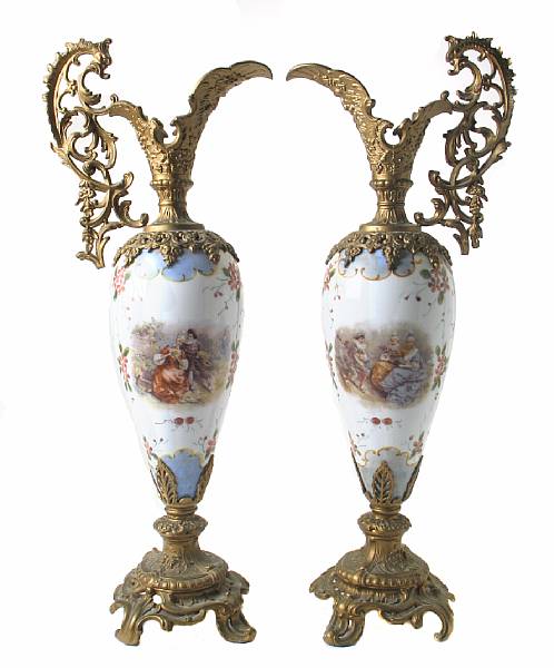 Appraisal: A pair of gilt metal mounted porcelain urns in the