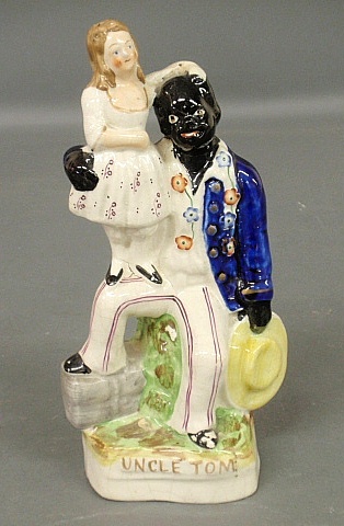 Appraisal: - Staffordshire seated Uncle Tom holding Miss Eva h x