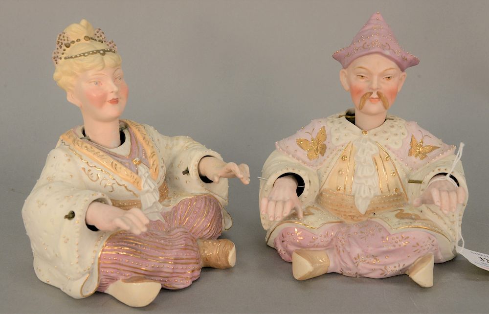 Appraisal: Porcelain male and female nodder figures polychrome and gilt painted