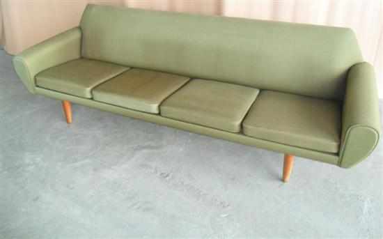 Appraisal: A DANISH FOUR SEAT SOFA in original green upholstery raised