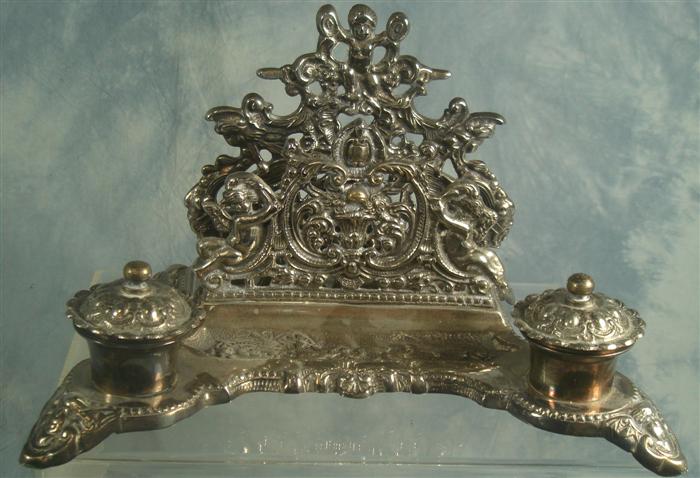 Appraisal: Plated silver desk stand cherub floral design w h Estimate