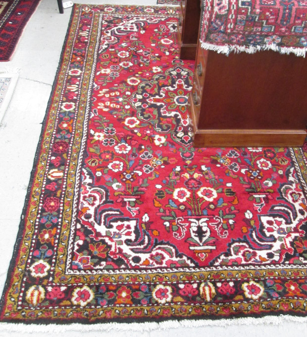 Appraisal: PERSIAN SEMI-ANTIQUE AREA RUG floral and central floral medallion design