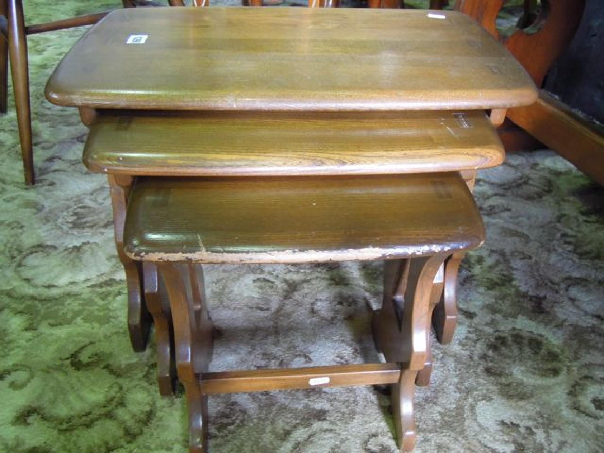 Appraisal: A nest of three Ercol stained elm graduated occasional tables