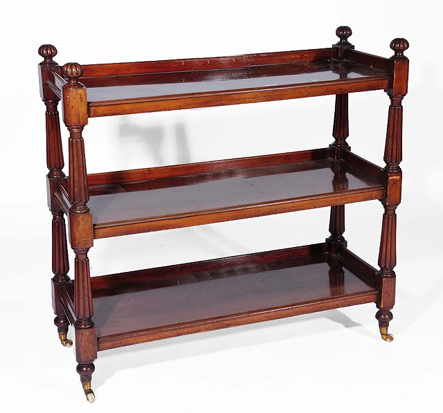 Appraisal: A Victorian mahogany bookcaseof three tiered form with reeded supports