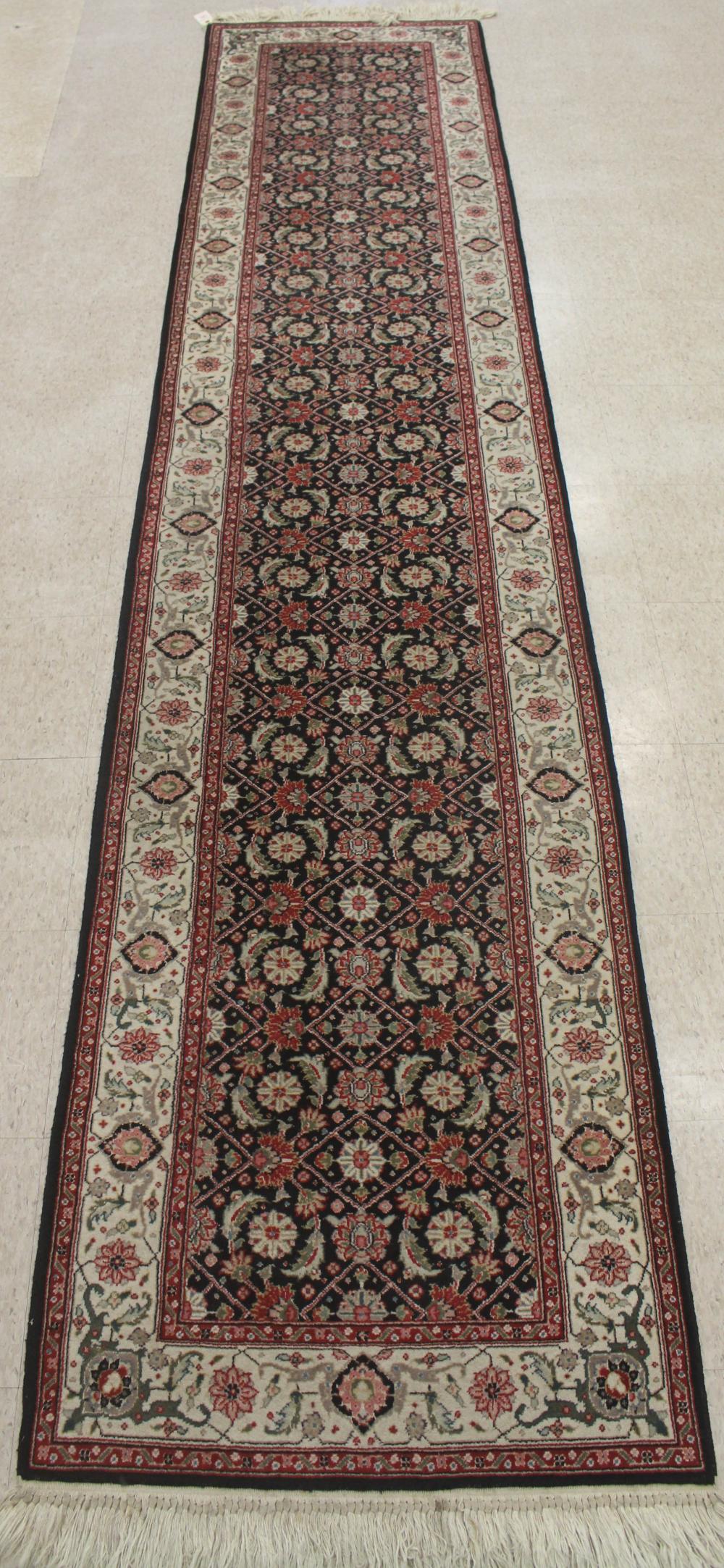 Appraisal: HAND KNOTTED ORIENTAL RUNNER Indo-Persian overall Herati floral design on