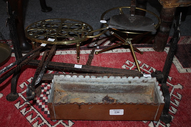 Appraisal: A GROUP OF FIRE IMPLEMENTS to include tongs a trivet