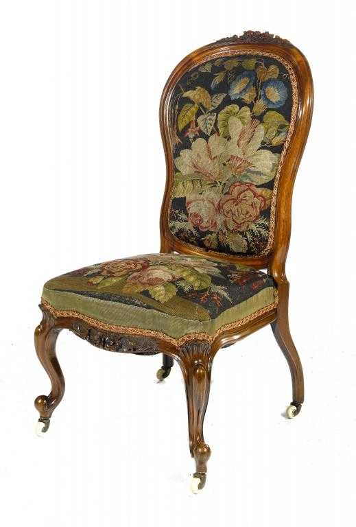 Appraisal: A VICTORIAN ROSEWOOD NURSING CHAIR the moulded back crested by