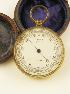 Appraisal: A gilt brass aneroid barometer with a silvered dial inscribed