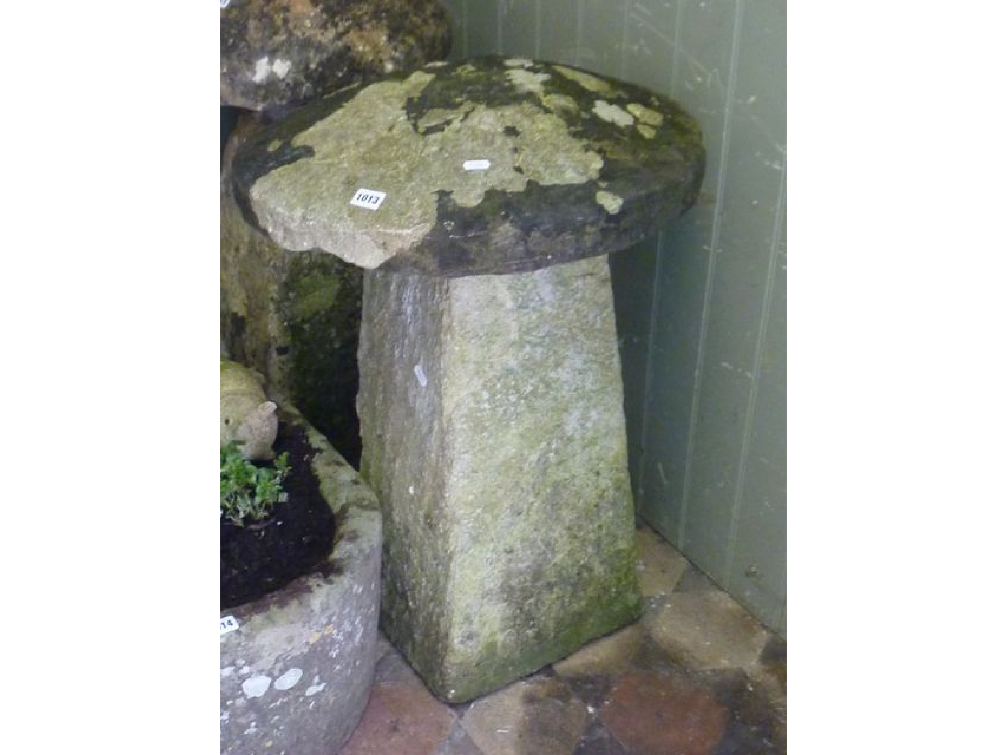 Appraisal: A Cotswold stone staddle stone and cap