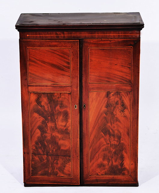 Appraisal: A GEORGE III MAHOGANY APOTHECARY'S CABINET the interior fitted twenty