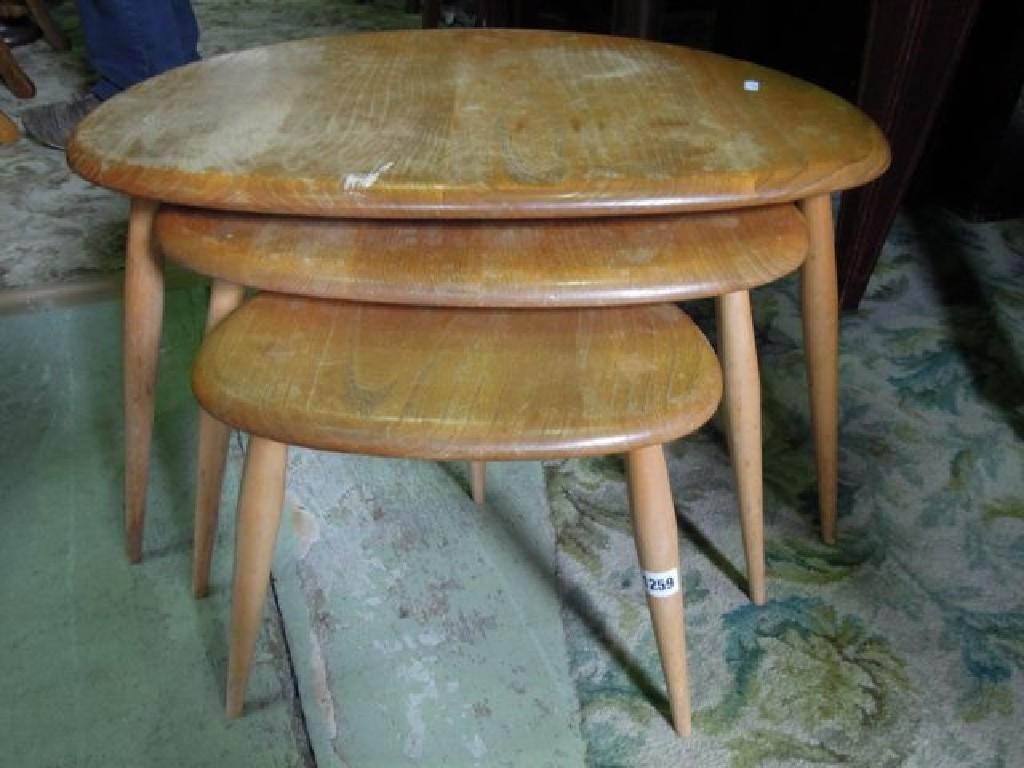 Appraisal: An Ercol light elm and beechwood nest of graduated pebble