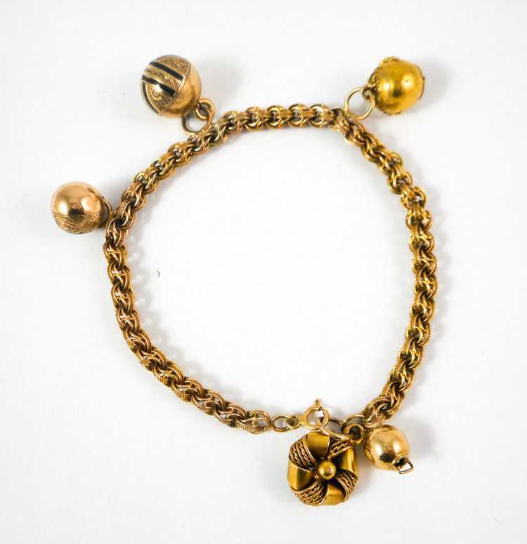 Appraisal: FOURTEEN KARAT GOLD CHARM BRACELET having a yellow gold chain