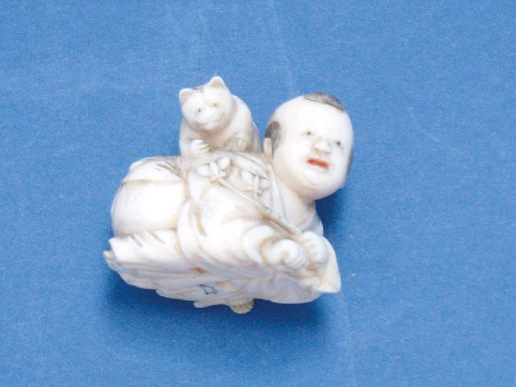 Appraisal: A JAPANESE IVORY NETSUKE of a crouching figure with an