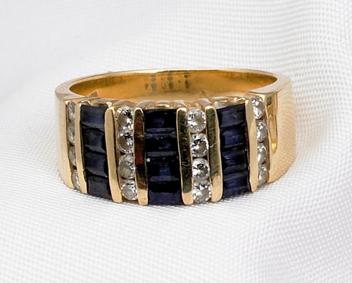 Appraisal: K yellow gold sapphire and diamond ring with channel set