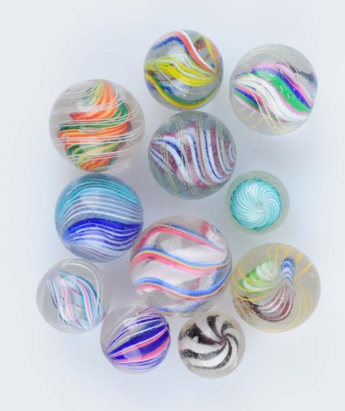 Appraisal: Lot Of Swirl Marbles Lot includes multicolor solid and divided