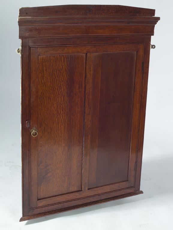 Appraisal: EARLY th CENTURY OAK HANGING CORNER CUPBOARD with twin panelled