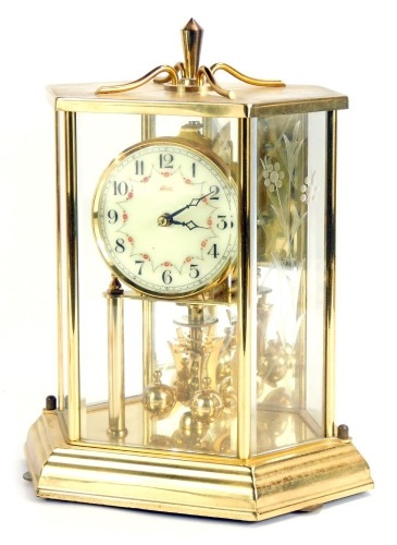 Appraisal: A Kundo brass cased hexagonal anniversary clock with a cream