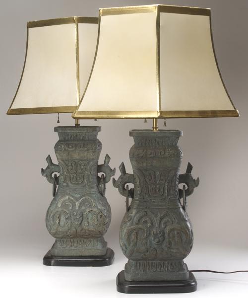 Appraisal: JAMES MONT Pair of earthenware lamps with embossed neoclassical designs