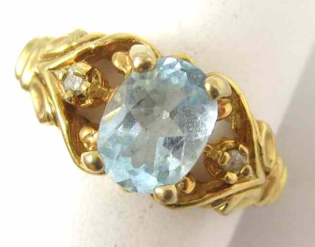 Appraisal: AQUAMARINE AND DIAMOND RING k yellow gold with a pair