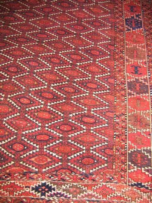 Appraisal: KHIWA BOCHARA antique Honeycomb patterned central field in red and