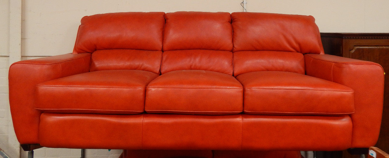 Appraisal: A modern three four seater settee upholstered in rust red