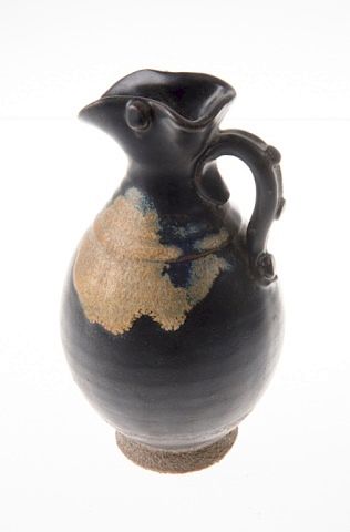 Appraisal: Chinese Black Pottery Ewer Chinese black pottery ewer with tan