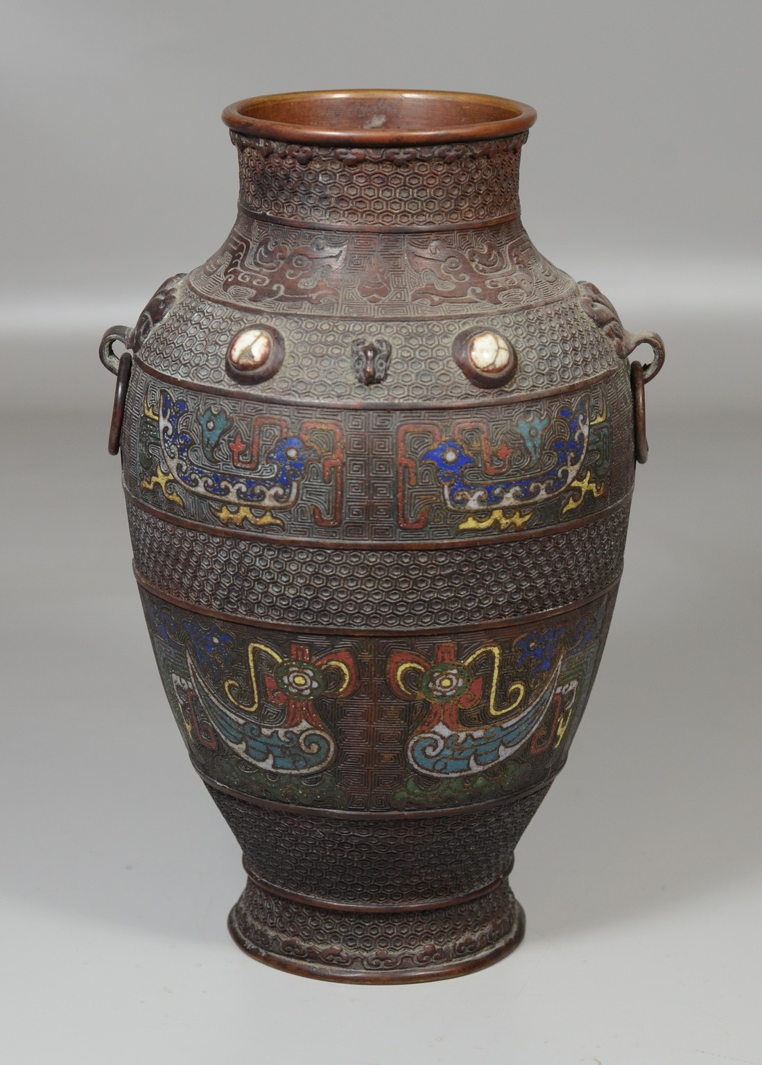 Appraisal: Japanese champleve enameled bronze vase archaic design mask handles with