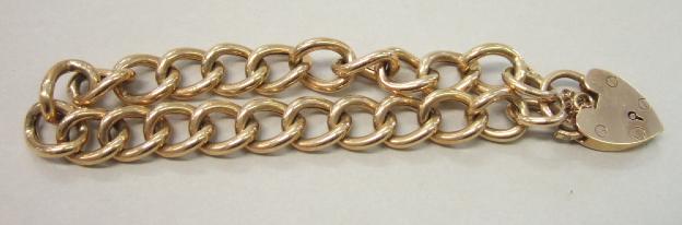 Appraisal: A gold curb link bracelet on a ct gold heart