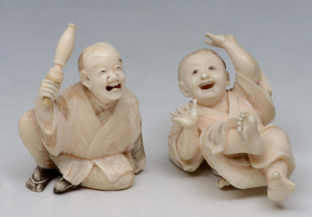 Appraisal: A JAPANESE IVORY OKIMONO seated man with rolled umbrella and