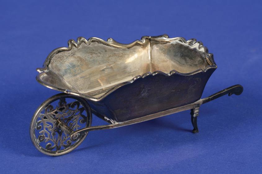 Appraisal: AN EDWARDIAN NOVELTY WHEELBARROW with a wavy border and a