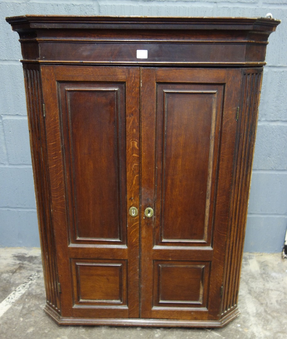 Appraisal: A George III oak and mahogany wall hanging corner cabinet