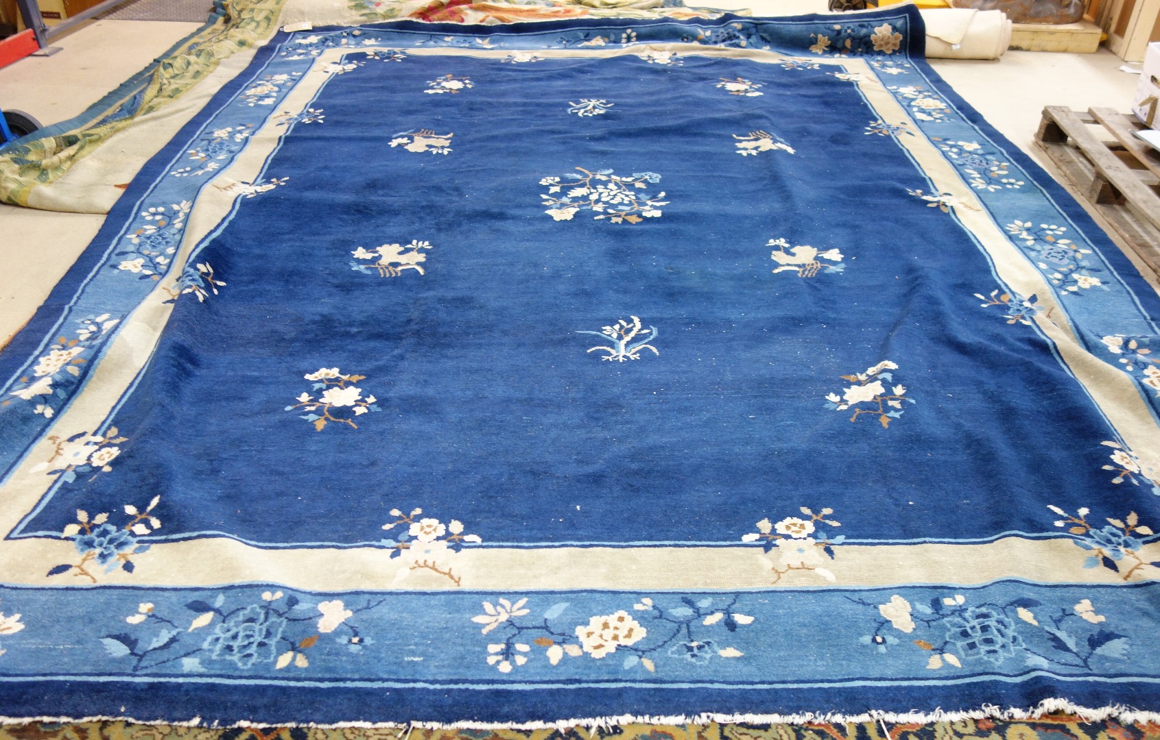 Appraisal: A Chinese carpet the dark indigo field with delicate floral