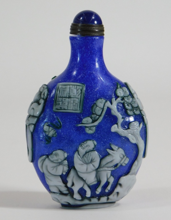 Appraisal: CHINESE BLUE SNOWFLAKE OVERLAY SNUFF BOTTLE China th CenturyWhite overlay