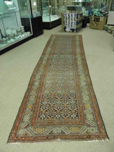 Appraisal: A Caucasian wool runner with a geometric bordered pattern Hand