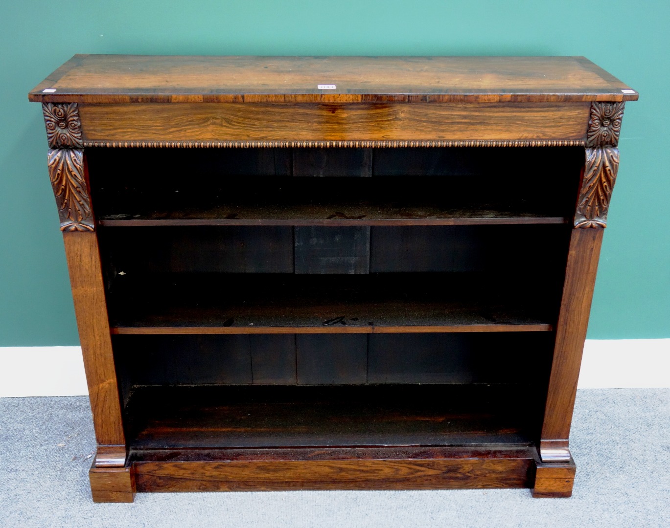 Appraisal: An early th century crossbanded rosewood floor standing open bookcase