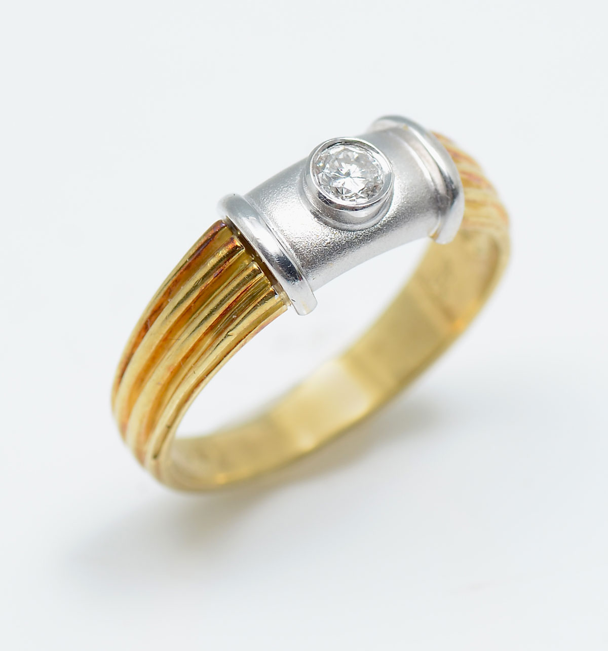 Appraisal: TONE K FLUTED RING WITH BEZEL SET DIAMOND K yellow