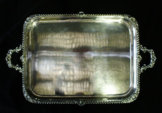 Appraisal: A silver plated twin handled tray with gadrooned floral and