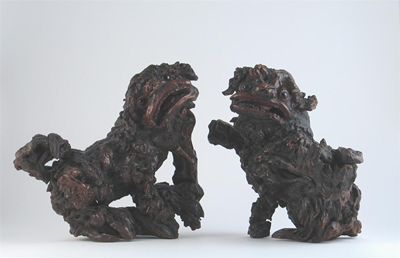 Appraisal: Two Chinese root-wood carvings of lion dogs with inset stone