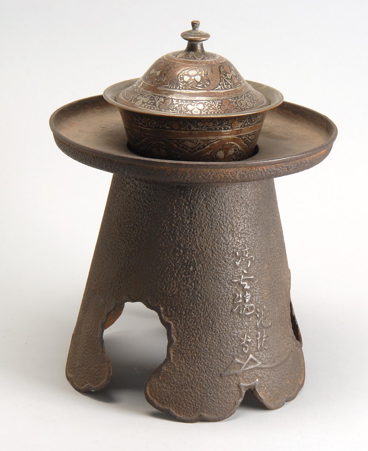 Appraisal: IRON USABATA Early th CenturyWith conical base in cloud design