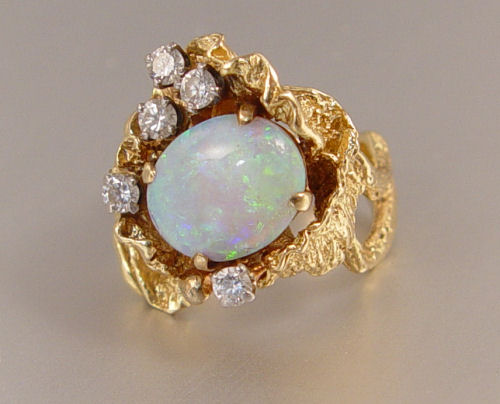 Appraisal: CT OPAL RING WITH DIAMONDS K yellow gold nugget style