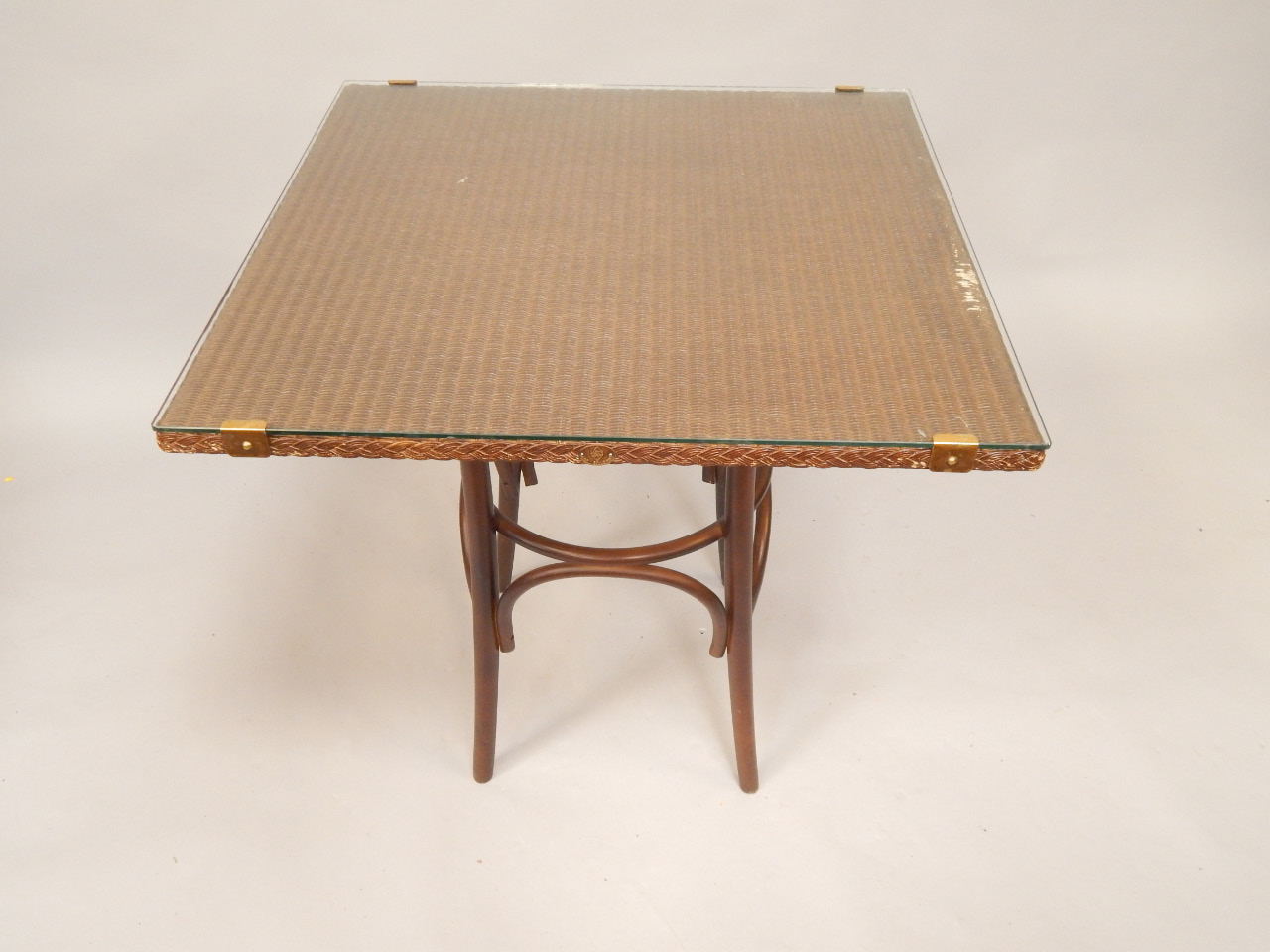 Appraisal: A Lloyd Loom square top table with plate glass top