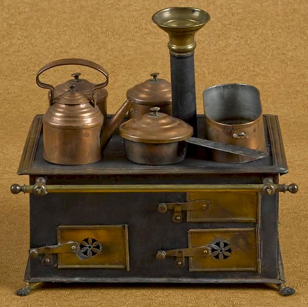 Appraisal: Brass and tin toy stove with copper cooking acces Brass